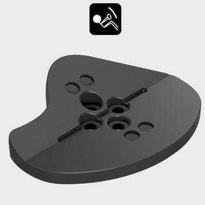 May include: A dark gray, ergonomic chair base with multiple circular and oblong holes. The base has a curved shape and a smooth, matte finish. A small, black square icon with a person sitting in a chair is in the upper right corner.
