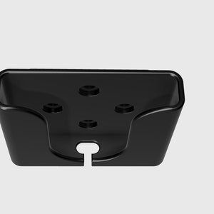 May include: Black plastic phone holder with four screw holes and a cut-out for a charging cable.