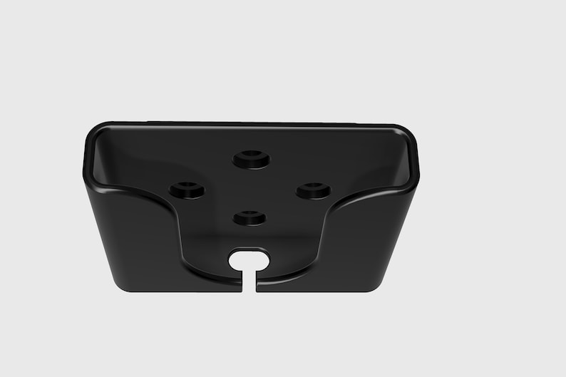 May include: Black plastic phone holder with four screw holes and a cut-out for a charging cable.