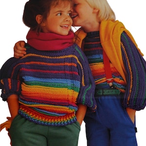 May include: Two children wearing colorful, rainbow-striped crochet sweaters. The sweaters have a round neckline and short sleeves. One child wears green sweatpants, the other wears blue sweatpants. The children are smiling and appear to be whispering.
