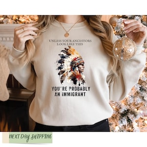 a woman wearing a sweatshirt that says you're probably an immigrant