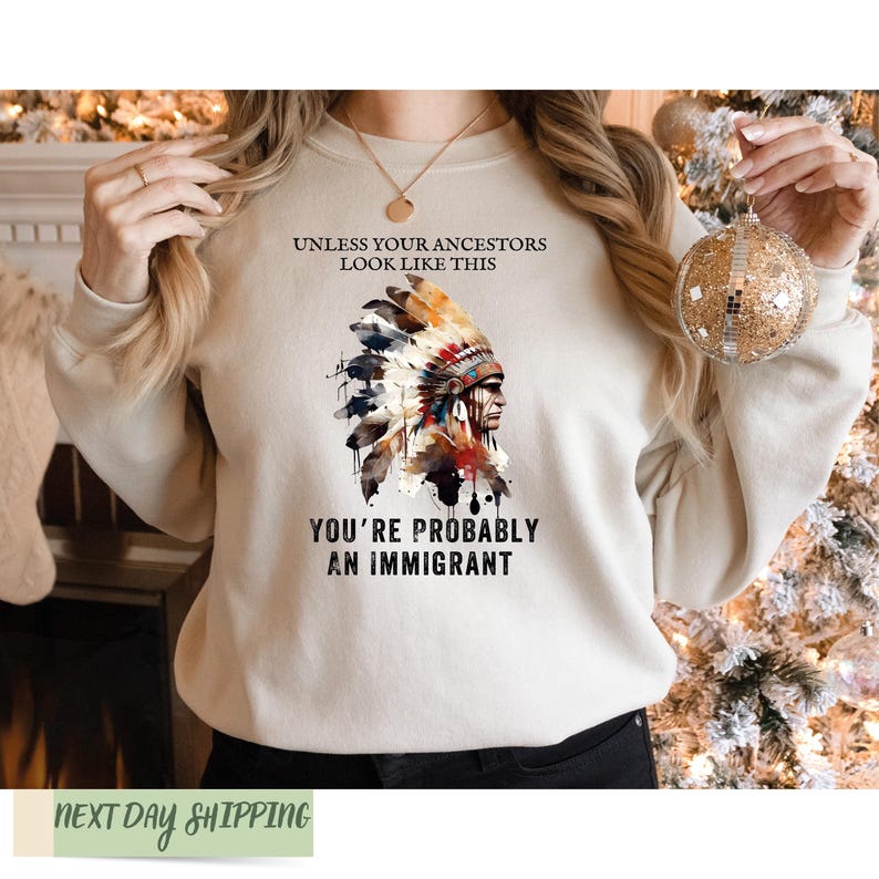 a woman wearing a sweatshirt that says you're probably an immigrant