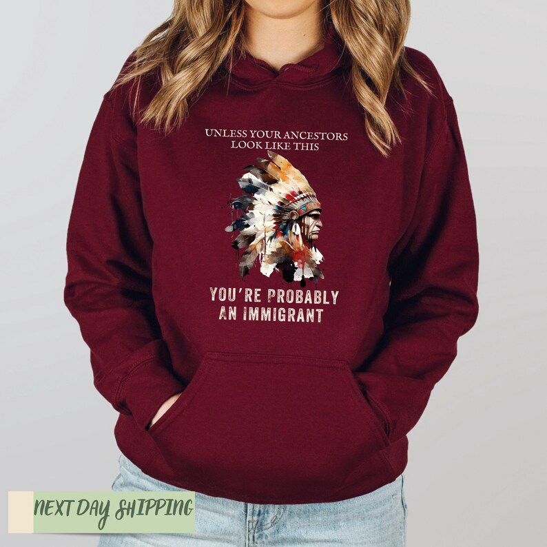 a woman wearing a maroon hoodie with an american flag on it