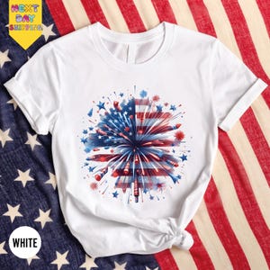 a white shirt with a red, white and blue fireworks on it