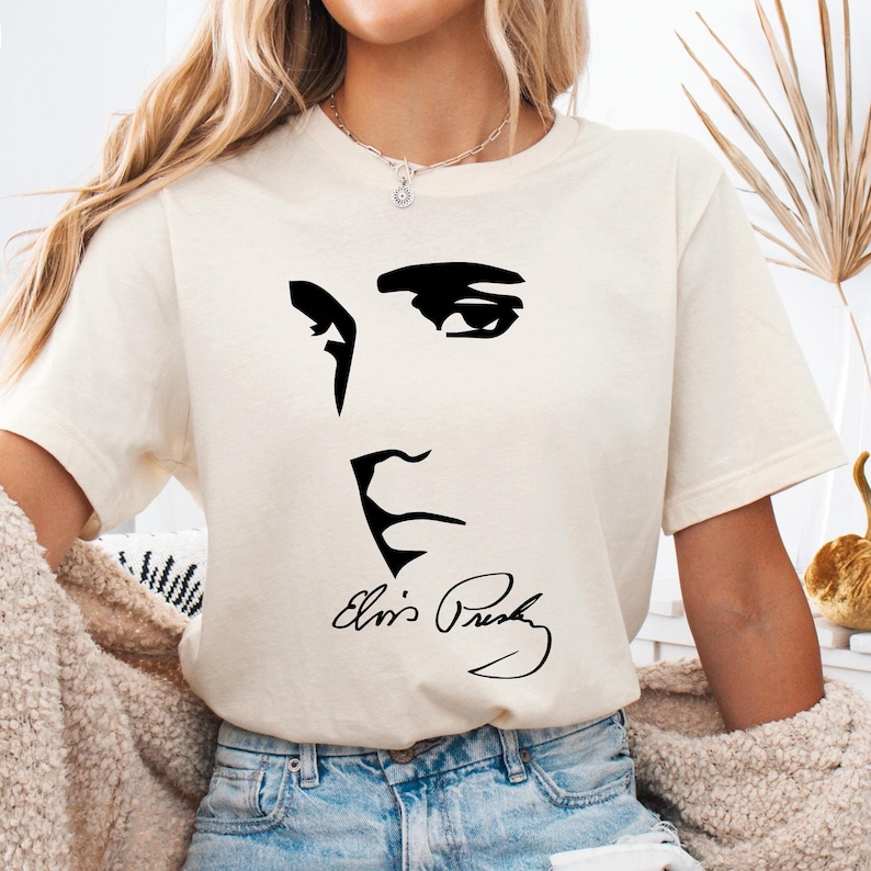 a woman wearing a t - shirt with a picture of elvis presley on it