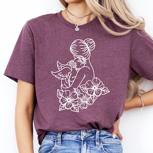 a woman wearing a t - shirt with flowers on it
