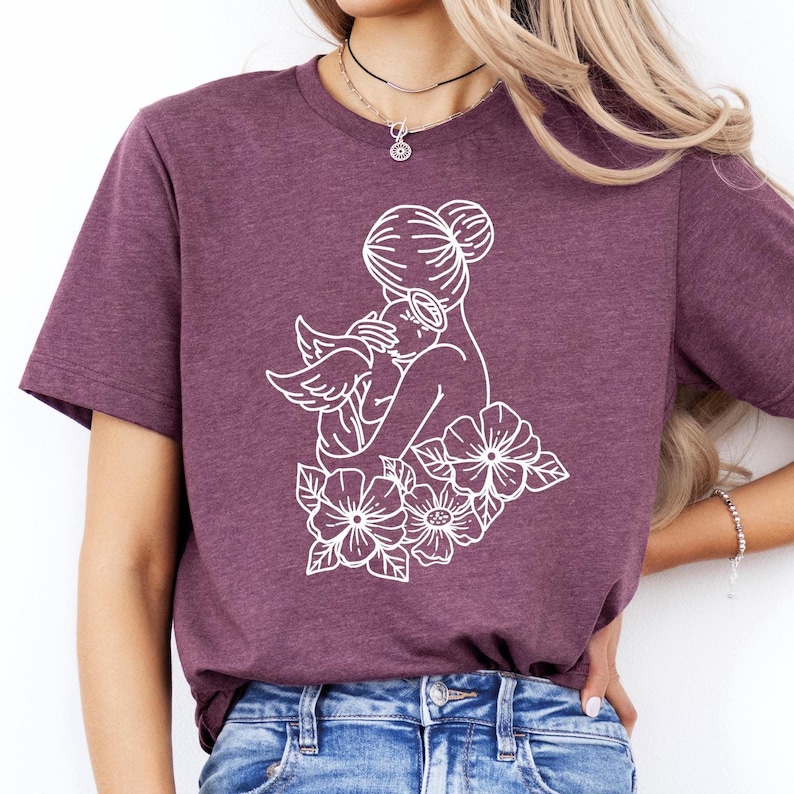a woman wearing a t - shirt with flowers on it
