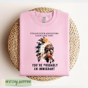 a pink shirt with a native american headdress on it