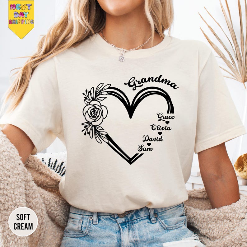 a woman wearing a t - shirt with a heart and flowers on it