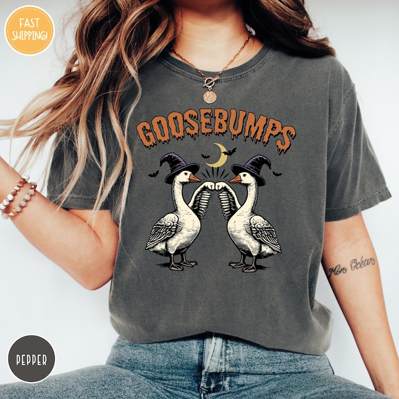 a woman wearing a t - shirt with two geese on it