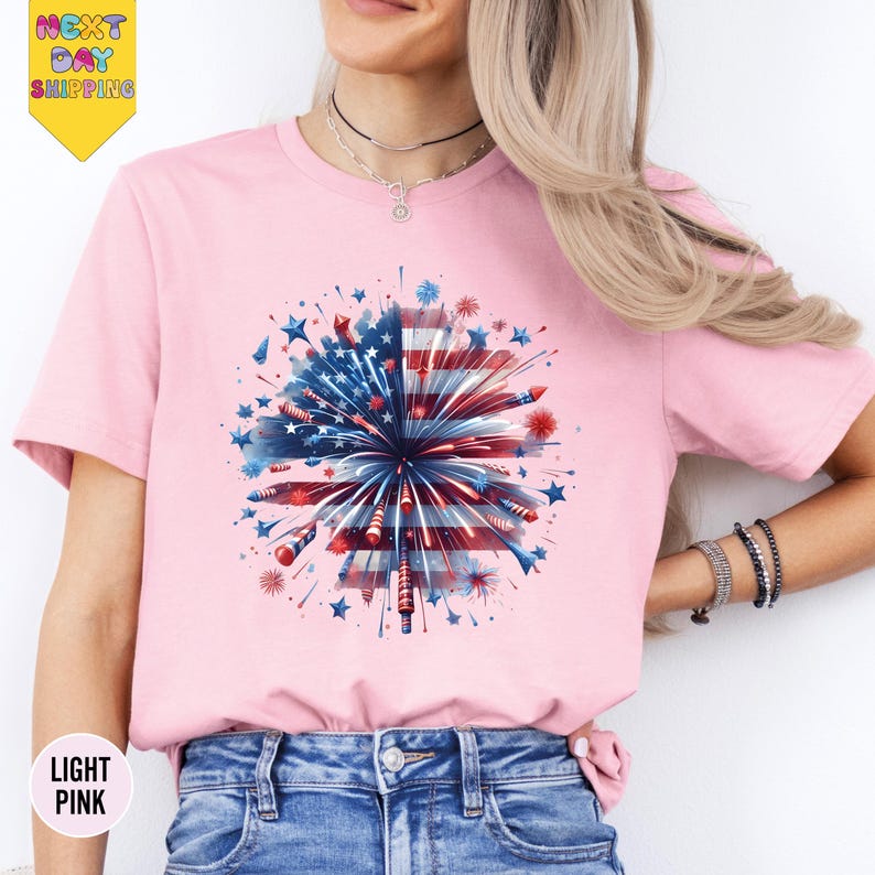 a woman wearing a pink t - shirt with an american flag design