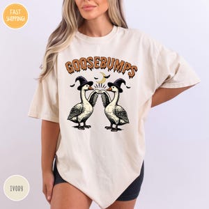 a woman wearing a t - shirt with two geese on it