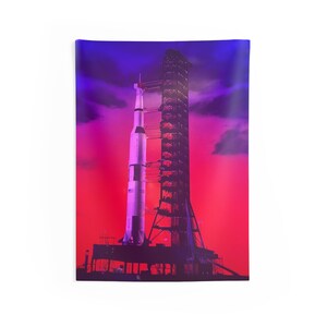 May include: A white rocket on a launchpad against a red and purple sky. The rocket is tall and slender with a pointed nose cone. The launchpad is a large metal structure with multiple levels. The sky is a vibrant red and purple with clouds.