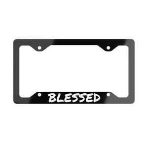May include: A black license plate frame with the word "BLESSED" in white script. The frame has a rectangular shape with rounded corners and mounting holes.