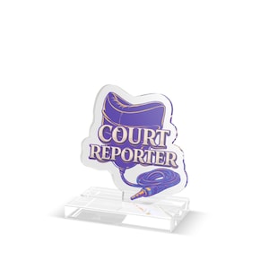 May include: A clear acrylic award featuring the text "COURT REPORTER" in purple and white. The design includes a purple chair and a microphone cable. The award sits on a clear rectangular base.