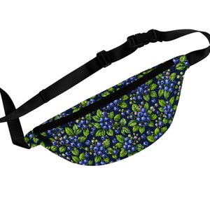 May include: A navy blue fanny pack with a vibrant blueberry pattern. The design features clusters of blue berries, green leaves, and small pink accents. The bag has a black adjustable strap and a black buckle closure.