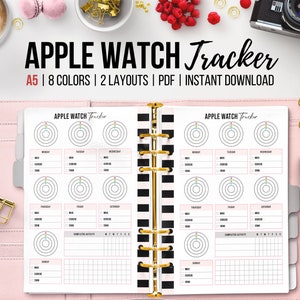 Peut inclure: Un agenda A5 rose avec une mise en page de suivi Apple Watch. Le suivi a une mise en page hebdomadaire avec des cercles pour suivre l'activité. Le texte "APPLE WATCH Tracker" est en haut.