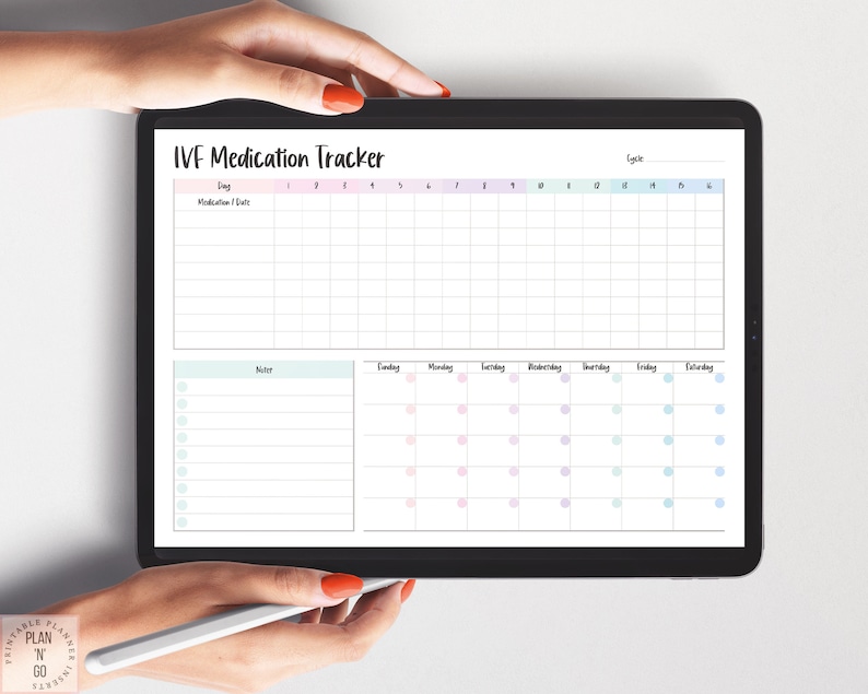 May include: A digital IVF Medication Tracker displayed on a tablet. The tracker features a grid for medication and date entries, a notes section, and a calendar. The text "IVF Medication Tracker" is at the top. The tablet is held by hands.