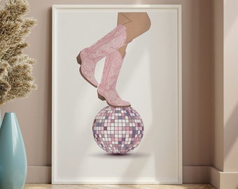 May include: A framed print of a pair of pink cowboy boots standing on a disco ball. The background is a light pink wall.