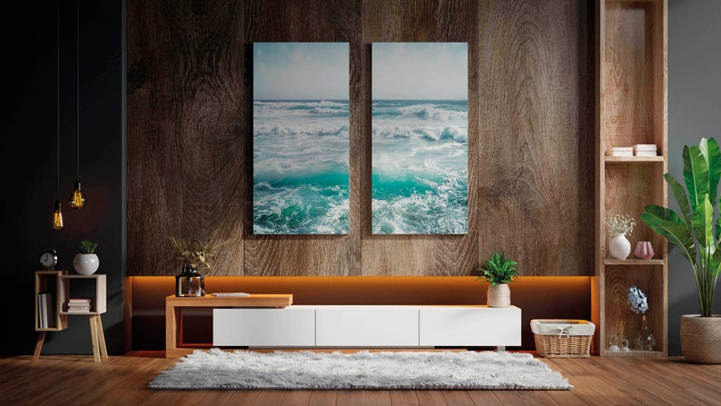 May include: A modern living room with a wooden accent wall and a white entertainment center. Two framed ocean wave prints hang above the center. A fluffy gray rug and a potted plant add to the room's decor. Decorative lighting and shelving complete the space.
