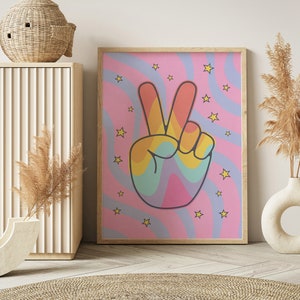 May include: A pink and blue psychedelic print with a rainbow peace sign. The print features yellow stars and wavy lines.