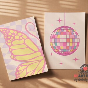 May include: Two art prints with retro designs. One features a butterfly wing in pink and yellow on a checkered background. The other showcases a disco ball with pink, yellow, and blue squares, surrounded by stars.