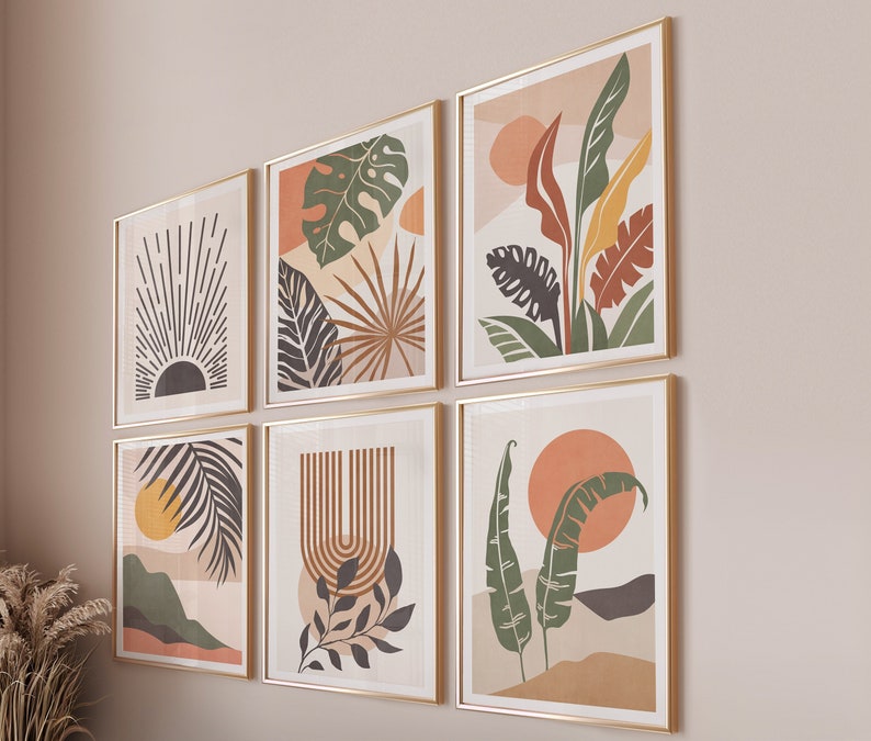 May include: Set of six abstract art prints featuring various botanical illustrations in shades of green, brown, and orange. The prints are framed in gold and arranged in a grid pattern on a light beige wall.