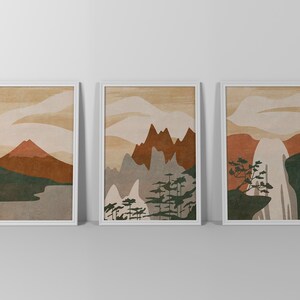 May include: Three framed prints with abstract mountain landscapes in shades of brown, green, and white. The prints are set against a white background.