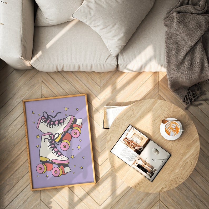May include: A framed print of a pair of pink and white roller skates with yellow stars on a purple background.