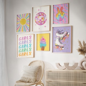 May include: A set of six colorful wall prints featuring a disco ball, a peace sign, roller skates, ice cream, and the word "Girls" repeated five times. The prints are framed in gold and have a retro aesthetic.