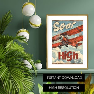 May include: Printable wall art featuring a vintage-style illustration of a red airplane soaring through the clouds with the text "Soar High". The artwork is framed in gold and displayed on a shelf with green walls and plants.