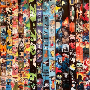 May include: A collection of colorful lanyards featuring various cartoon and movie characters. The lanyards are made of a durable fabric and feature a variety of designs, including characters from popular shows like "The Simpsons", "Rugrats", "The Powerpuff Girls", "The Office", "Friends", and "Star Wars".