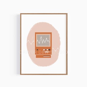 May include: A framed print featuring a retro-style orange computer monitor displaying a white waveform on a grid. The monitor is set against a light pink oval background, with white line graphs on either side. The artwork is in a wooden frame.