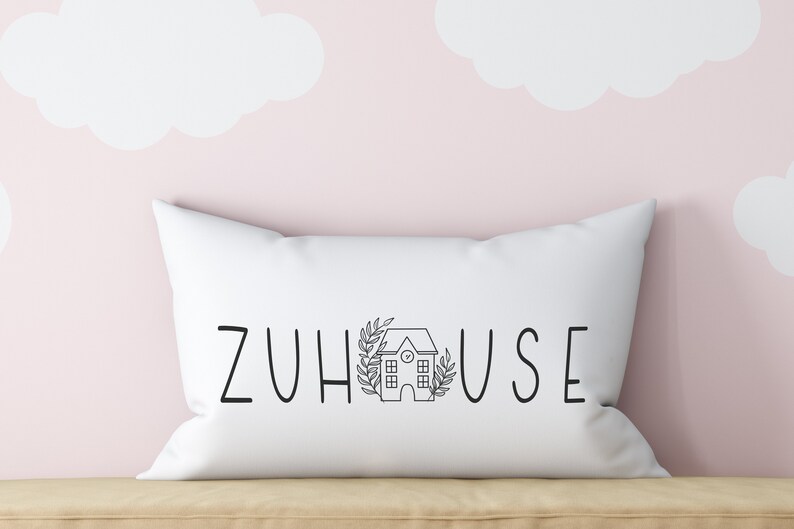 以下が含まれることがあります： 「ZUHAUSE」という黒い文字と小さな家のイラストが書かれた白い枕