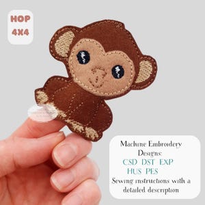 May include: A brown monkey-shaped machine embroidery design with tan accents. The design includes the text "HOP 4x4" and "Machine Embroidery Designs: CSD DST EXP HUS PES Sewing instructions with a detailed description."