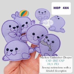 May include: A collection of purple felt seal embroidery designs. Some seals have a ball, fish, or are in different poses. The text "HOP 4X4" is in a white box. The text "Machine Embroidery Designs: CSD DST EXP HUS PES Sewing instructions with a detailed description" is also present.