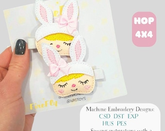 May include: Two white and pink bunny hair clips with embroidered faces and pink bows. The clips are on a white card with a light yellow polka dot pattern. The text "HOP 4x4" is in a pink box. The text "FireFly" and "@IVASTOYS" are also visible.
