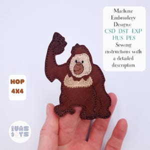 May include: A brown felt applique of a gorilla with a beige face and chest. The applique is held in a hand. Text on the image reads "HOP 4X4" and "Machine Embroidery Designs: CSD DST EXP HUS PES Sewing instructions with a detailed description."
