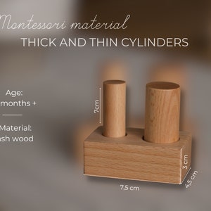 May include: A wooden Montessori toy featuring two cylinders of different thicknesses, each 7 cm tall, set in a wooden base. The base is 7.5 cm long and 4.5 cm wide. The text on the image says "THICK AND THIN CYLINDERS".