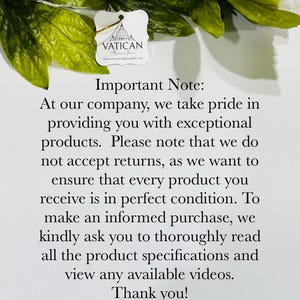 May include: A white tag with the word "VATICAN" and a logo of a building is attached to a gold string. The tag is surrounded by green leaves and text that reads "Important Note:" and "Vatican Religious Gifts."