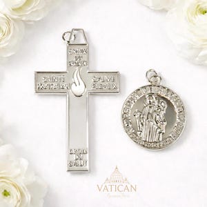 May include: Two silver religious pendants. One is a cross with the words "CROIX DU PARDON", "SAINTE PROTECTION", "SALVE BLEAUX", and "CROIX DU SALUT". The other is a round pendant with an image of a saint and the words "NOTRE DAME DE LOURDES".