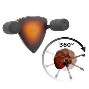 Könnte beinhalten: Ein Gitarren-Wandhalter mit einer braunen, holzähnlichen Oberfläche und zwei schwarzen Schaumstoffpolstern. Der Halter ist in Form eines Gitarren-Picks geformt und dreht sich um 360 Grad. Der Text "360°" ist auf dem Bild zu sehen.