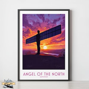May include: A framed art print of the Angel of the North sculpture at sunset. The artwork depicts the iconic silhouette of the angel with its wings spread wide, set against a sky of orange, purple, and pink. The text "ANGEL OF THE NORTH" is visible.