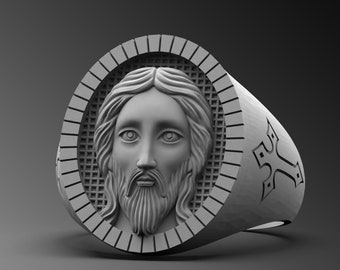 May include: A silver ring with a detailed image of Jesus' face on the front. The ring has a cross design on the band.