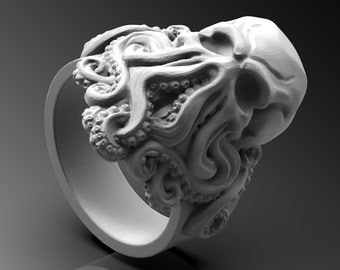 May include: A white, detailed ring with a skull and octopus design. The octopus tentacles are wrapped around the skull.
