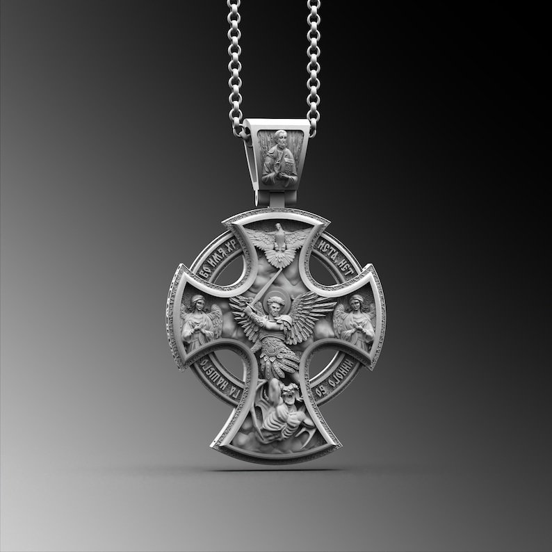 May include: Silver pendant with a cross design featuring an angel with wings and a sword. The cross has four sections with images of saints and the text "БОГЪ КМЪ ХРЪ" and "ИСТА ИСТ" in Cyrillic.