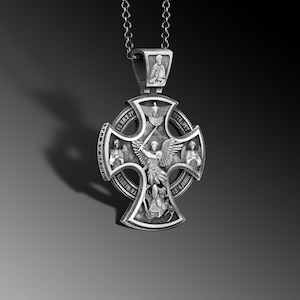 May include: Silver pendant featuring a cross with an angel holding a sword, surrounded by four smaller figures and text in Cyrillic script. The pendant is attached to a silver chain.