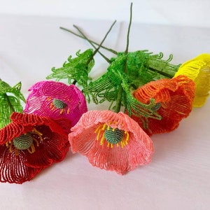 K&ouml;nnte beinhalten: Ein Strau&szlig; aus f&uuml;nf Perlenblumen mit gr&uuml;nen Stielen. Die Blumen sind rot, rosa, orange und gelb.