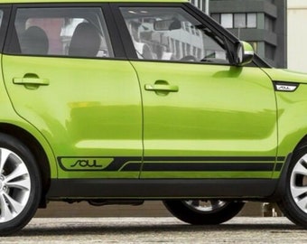 May include: A lime green Kia Soul with black side stripes and the word "Soul" in black lettering on the side of the car.