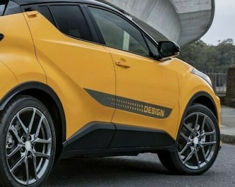 May include: A yellow car with black accents and a "DESIGN" decal on the side. The car has black wheels and a black roof.